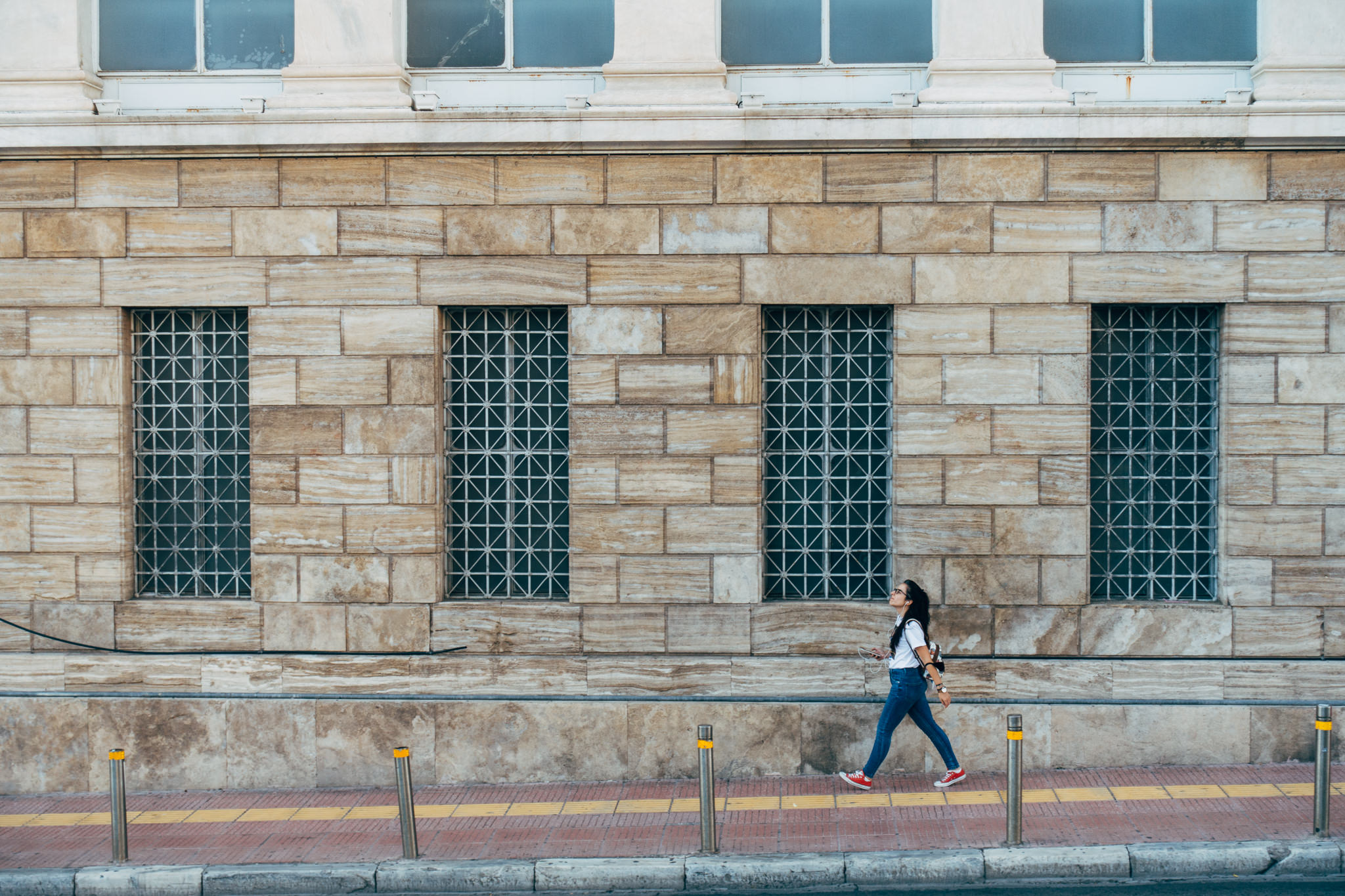 girl-walking-street-brick-wall