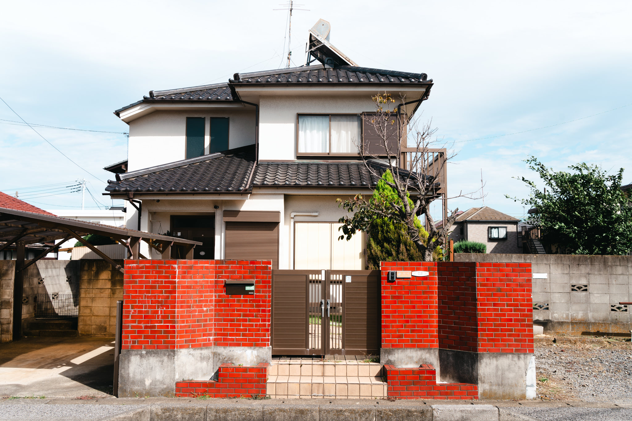 Traditional Japanese entrance gate with red accents