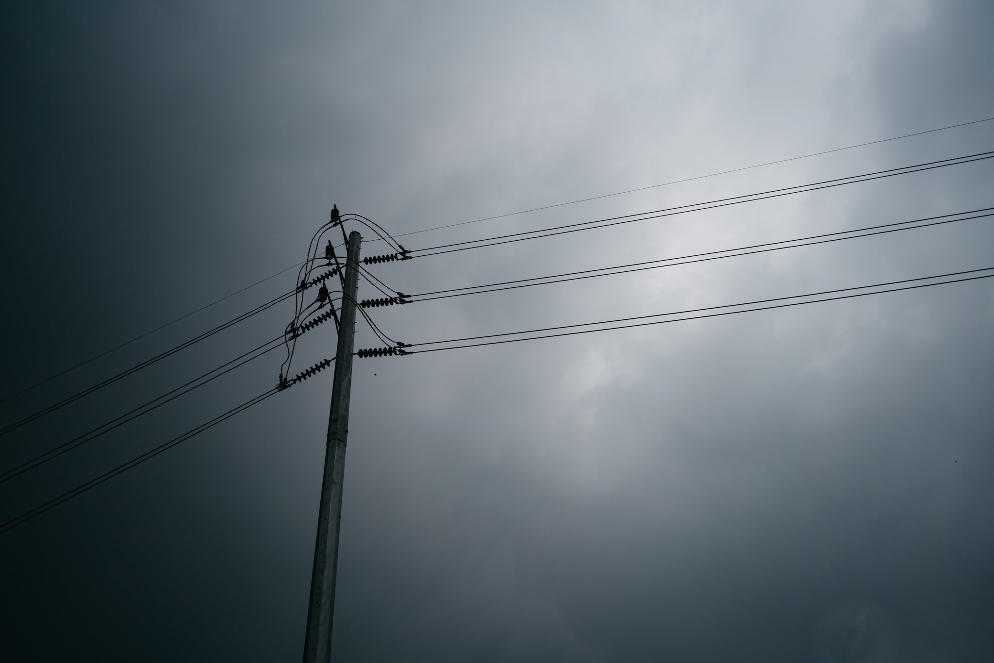 utility-pole-power-lines-stormy-sky